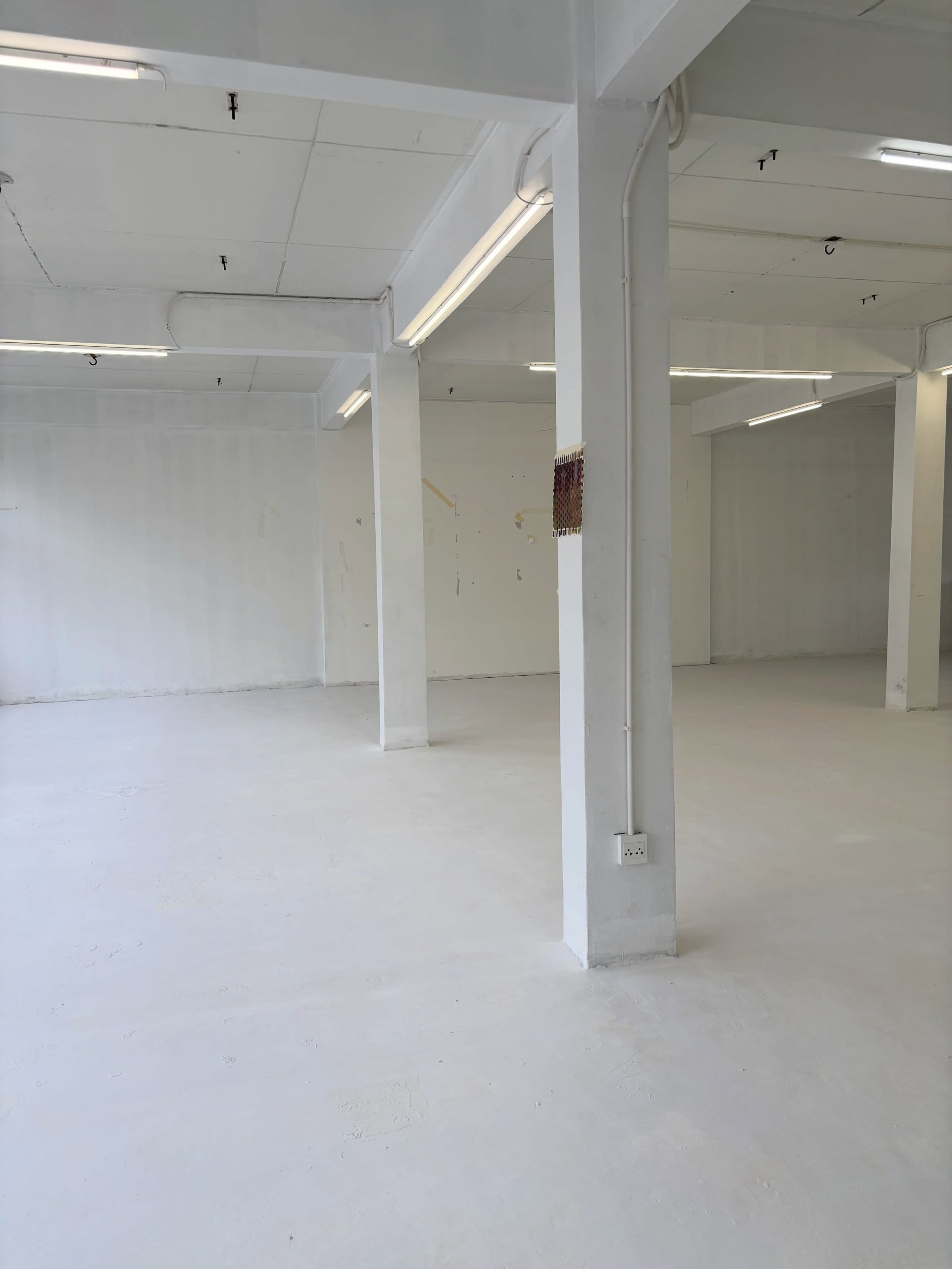 UNITED Unlimited, whitewashed studio floor with concrete columns, Thon Buri, Bangkok